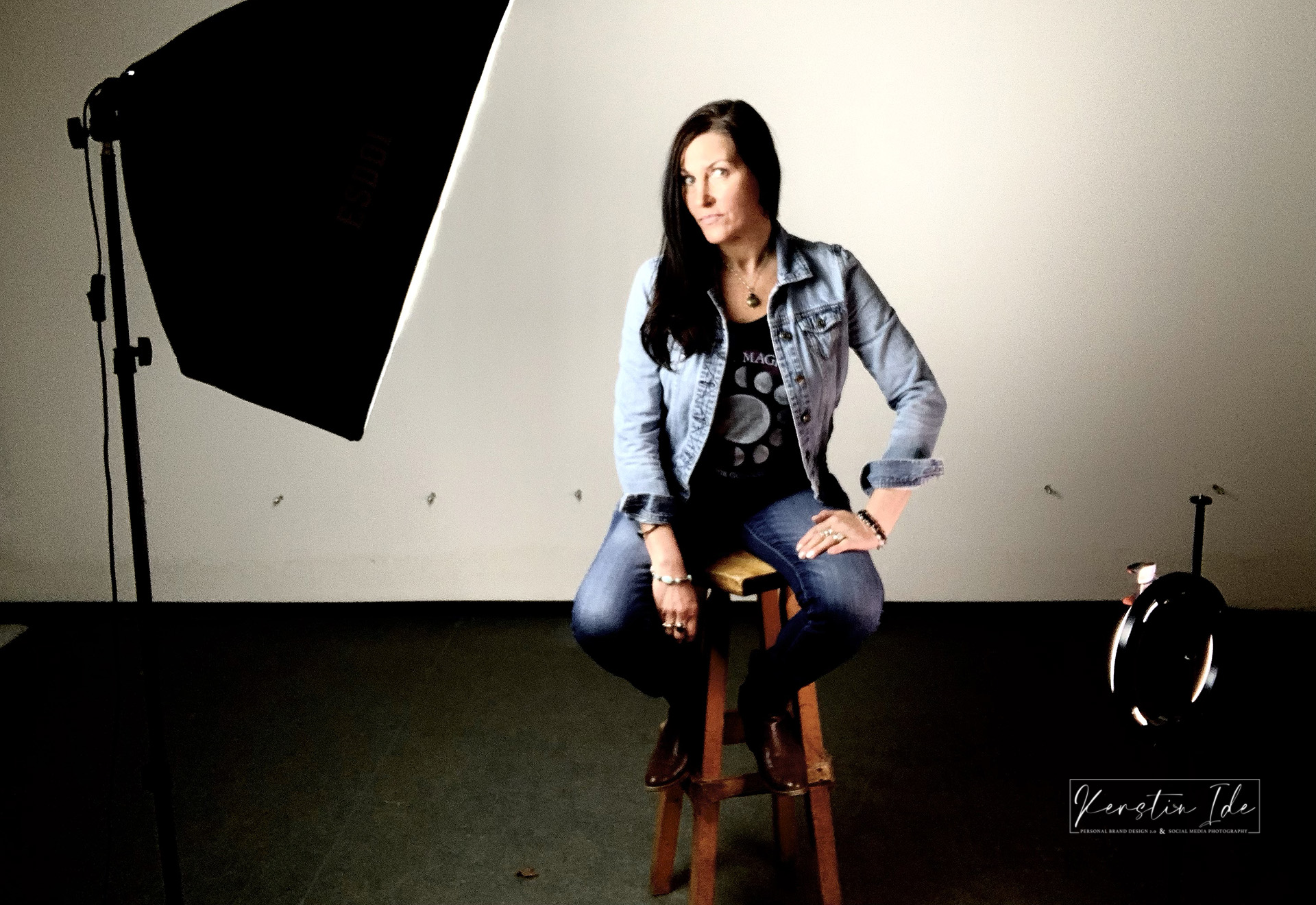 Kerstin Ide, sitting in Photo Studio in the spotlight.